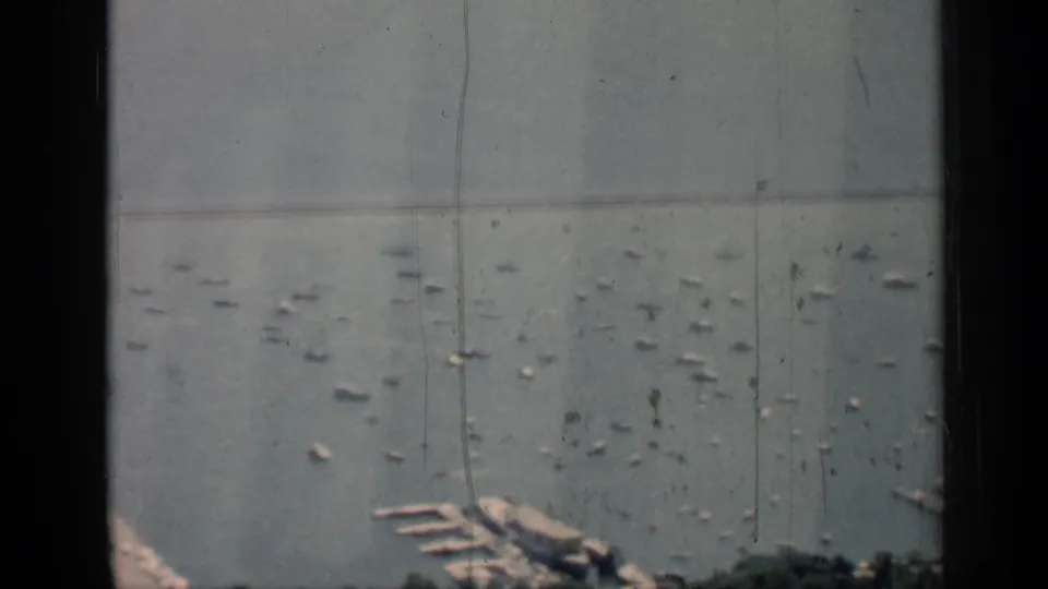 1958 Chicago harbor frame emphasizing small boats spread over the lake, with marina docks and shoreline details near the bottom edge.