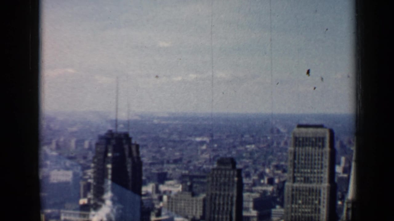 Chicago skyline seen from a high vantage point with tall buildings and hazy sky.