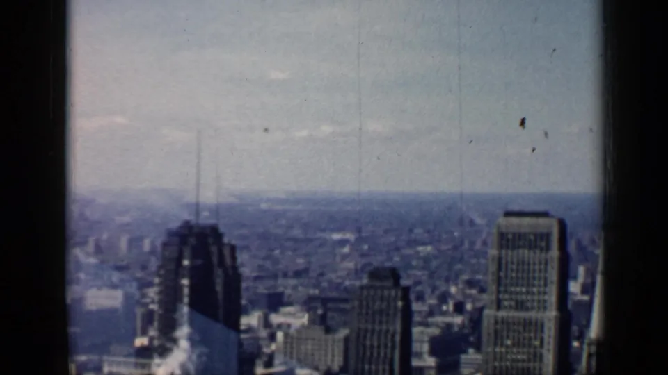 1958 Chicago skyline view from a high building, showing downtown towers, distant urban blocks, and soft 8mm film texture.