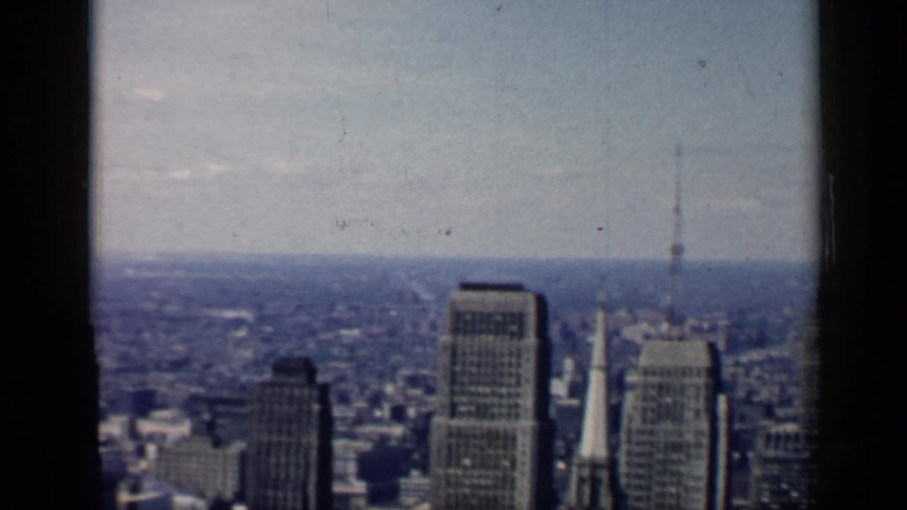 Downtown skyline with several tall buildings and a narrow steeple in the distance.
