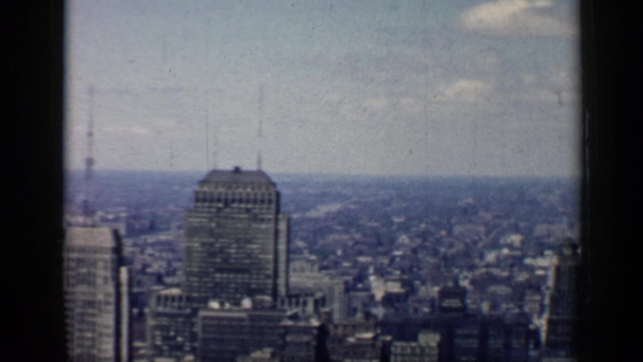 Chicago skyline seen from a high vantage point with tall buildings and a hazy horizon.