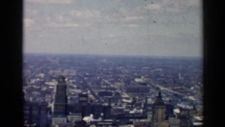 Elevated 1958 Chicago view with downtown towers in the foreground and lower urban development stretching toward the horizon.