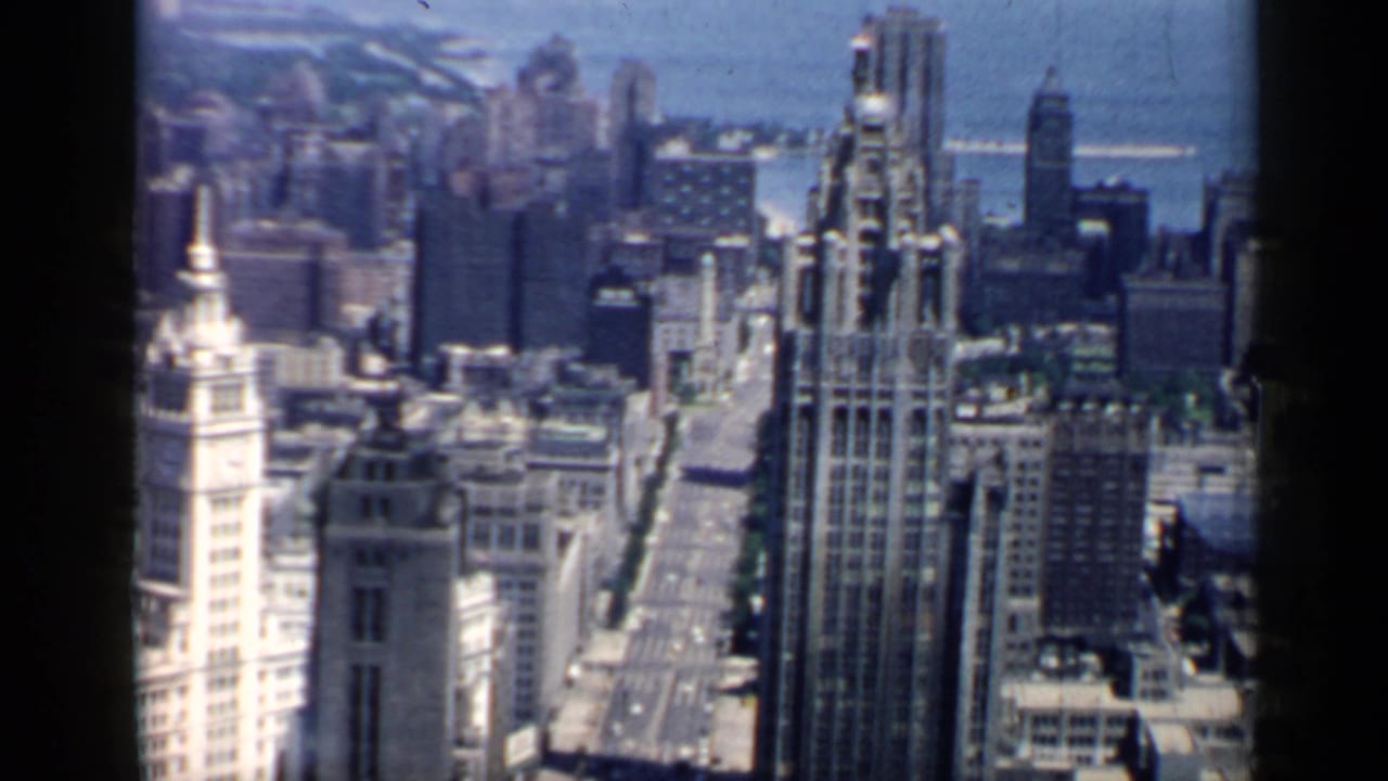 Downtown Chicago towers seen from a high vantage point with Lake Michigan beyond.