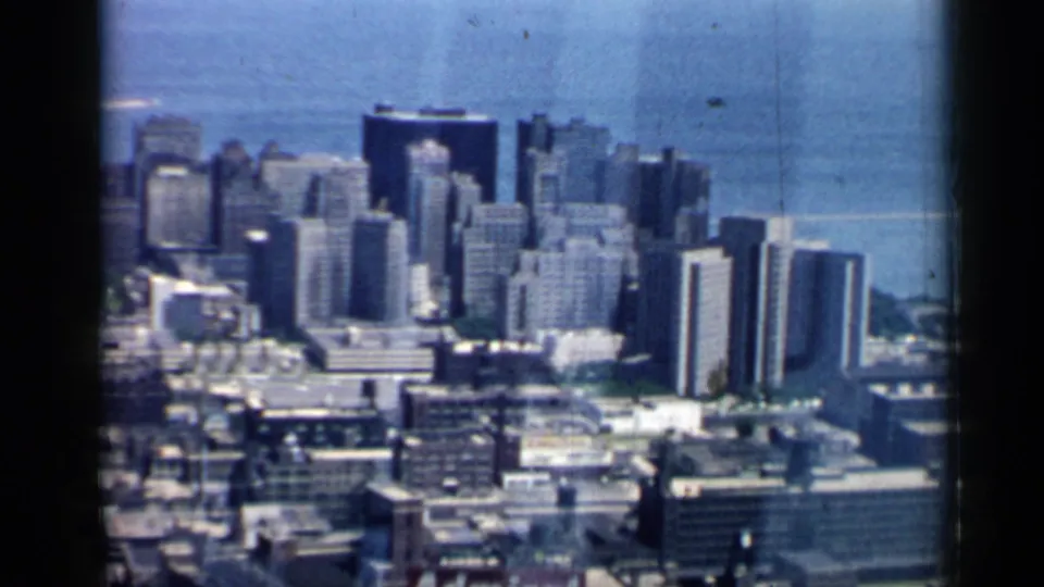 Chicago aerial skyline frame from 1958 showing downtown high-rises, rooftops, and Lake Michigan in the distance.