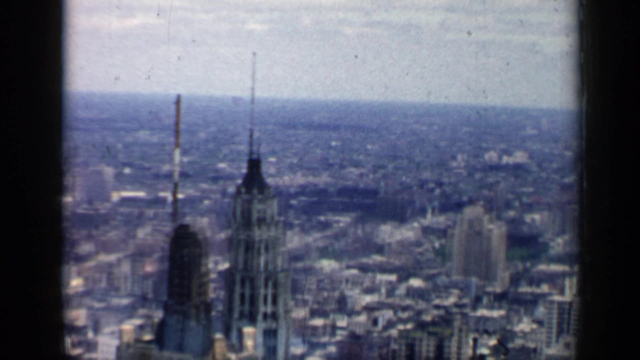 1958 Chicago skyline view with prominent spired towers in the foreground and the city stretching into haze.