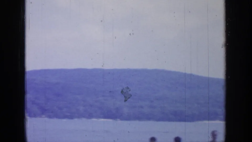 The final Greenwood Lake frame shows a wooded hillside, water in front, pale sky, and small partially visible figures along the bottom edge.