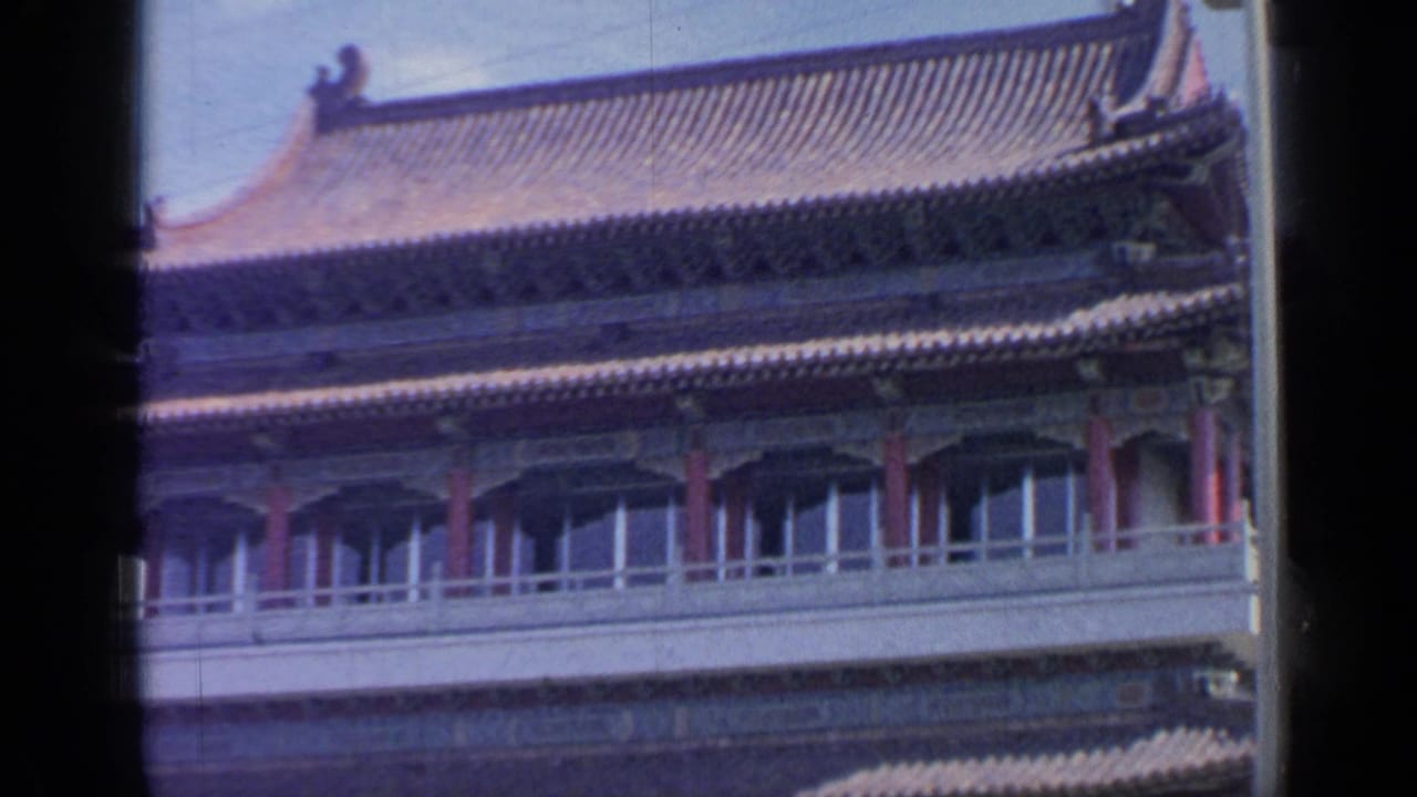 Traditional Chinese-style pavilion roofline with red columns and balcony railings.