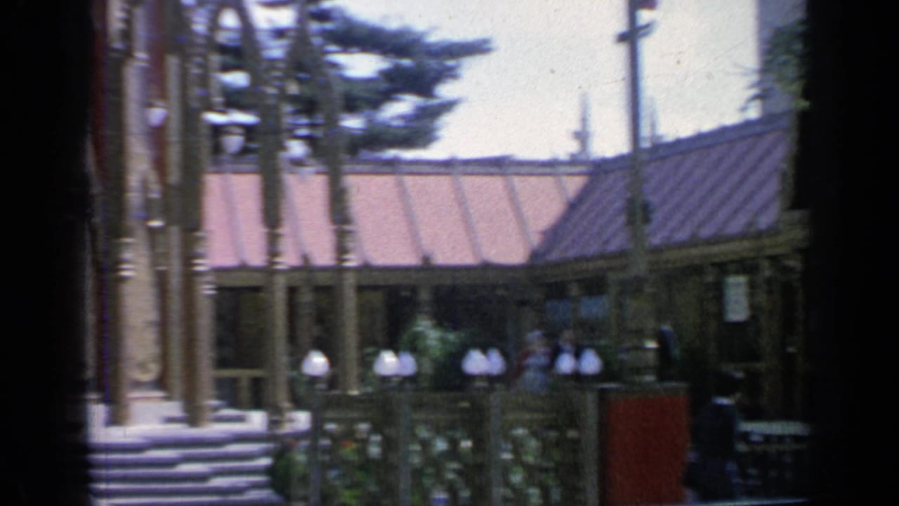 Thailand Pavilion exterior with steps, lamps, trees, and visitors near the entrance.
