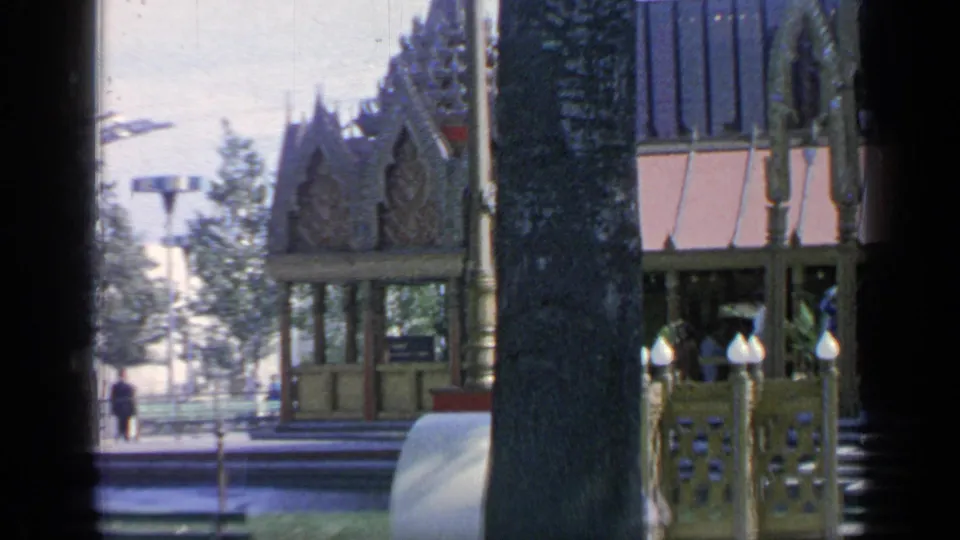 Late frame from a 1964 Flushing Meadows home movie showing the Thailand Pavilion entrance, railings, and visitors.