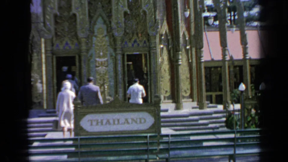 1964 World's Fair visitors approach the ornate Thai Pavilion entrance beneath a sign reading THAILAND.
