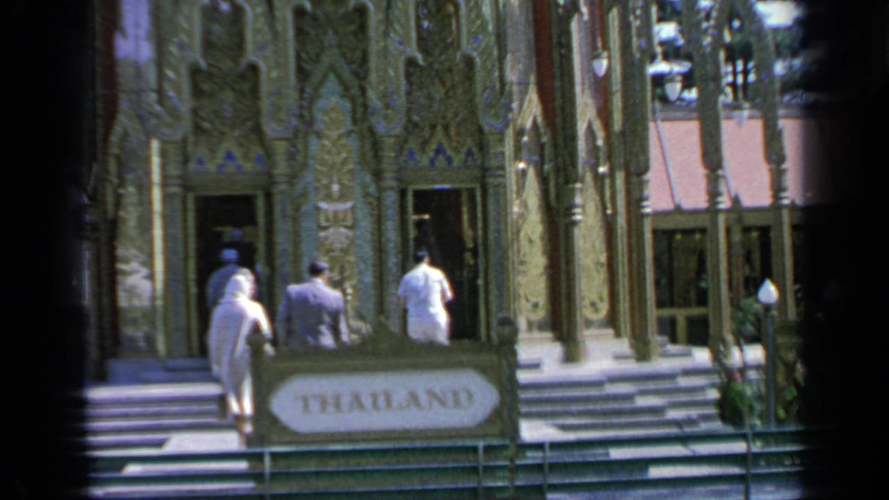 1964 Flushing Meadows fair visitors approach the Thailand pavilion, with an ornate facade and foreground THAILAND sign visible.