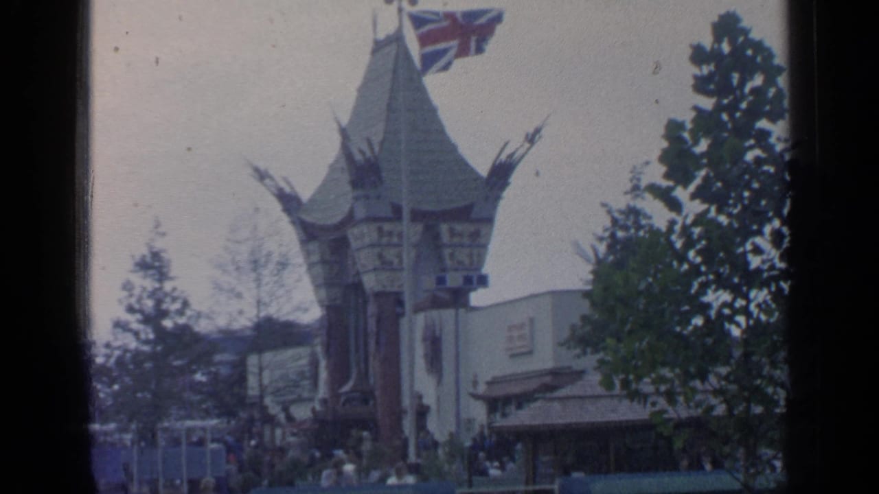 World's Fair pavilion at Flushing Meadows with a Union Jack flag, trees, and small groups of visitors near the entrance.