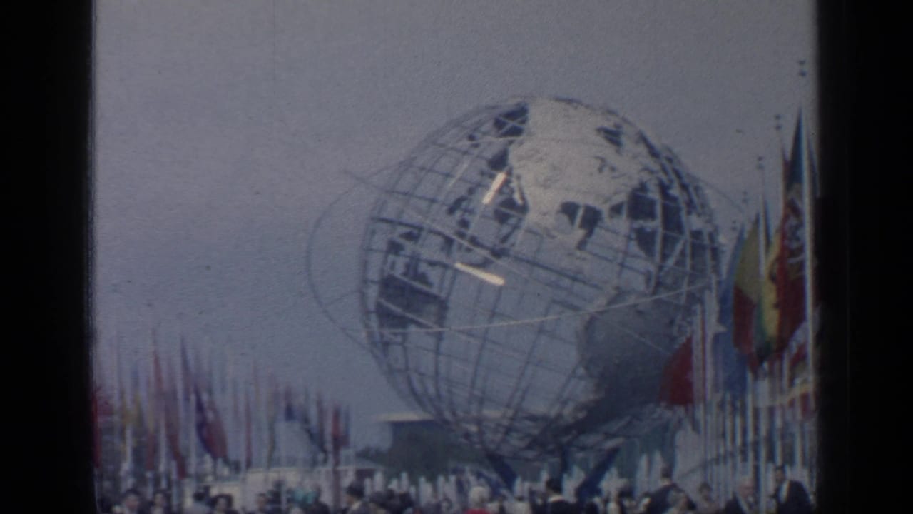 Unisphere centered behind a line of flags and small figures.