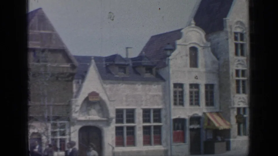 Visitor-level 1964 Flushing Meadows view of ornate gabled facades, large windows, and a striped awning.