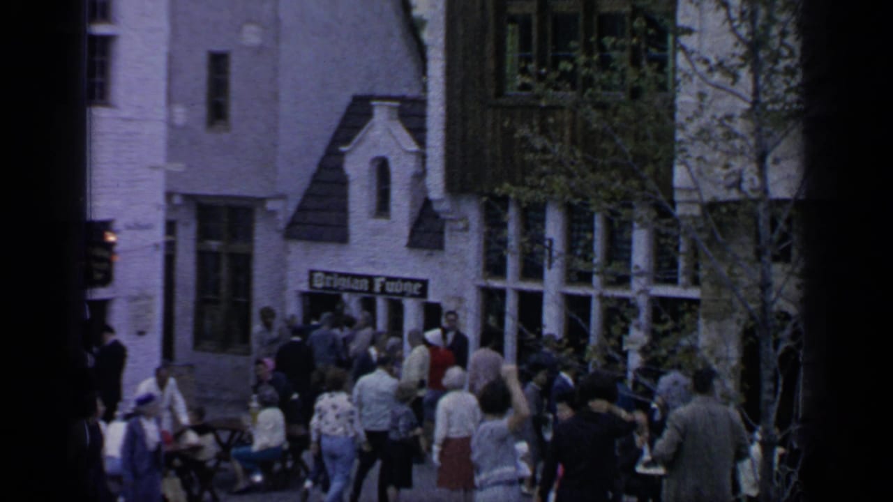 Crowd gathered outside a building with a German House sign.