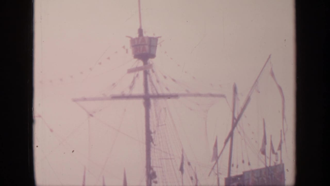 Ship model mast, crow's nest, rigging, and flags partly cropped at the right edge.