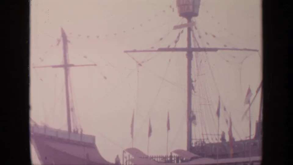 1964 Flushing Meadows view of the Santa Maria ship replica with mast, rigging, flags, and deck railing visible.