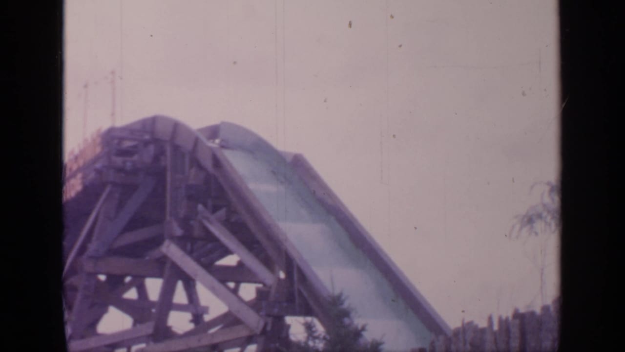 Roller coaster car begins to appear at the top of the drop.