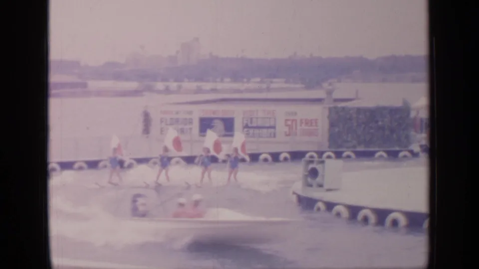 A speedboat passes performers or staff near the Florida Exhibit banner at the 1964 Flushing Meadows fairground water attraction.