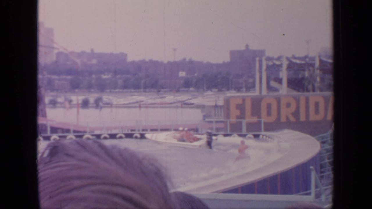 Water-ski show area with a Florida sign, ramp, floating platforms, and a spectator head in the foreground.