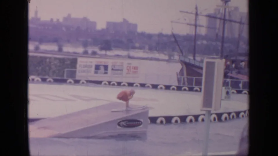 Water skier in red appears to leave a ramp during a stunt at the Florida exhibit area of the 1964 New York World's Fair.
