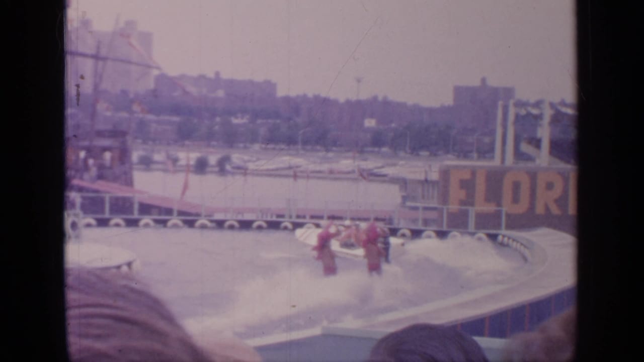 Two red-costumed waterskiers perform beside a FLORIDA sign during the 1964 Flushing Meadows fair water show.