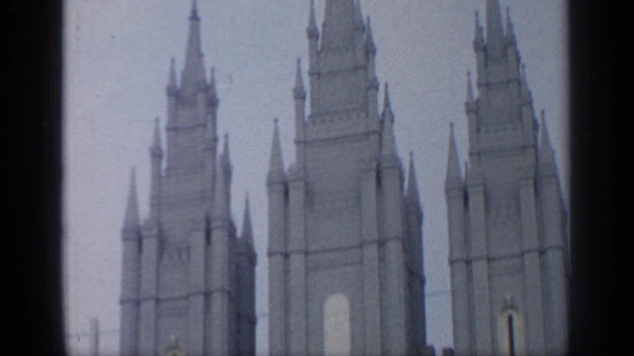 1964 Flushing Meadows frame showing several spired towers rising above the frame with soft 8mm color and grain.