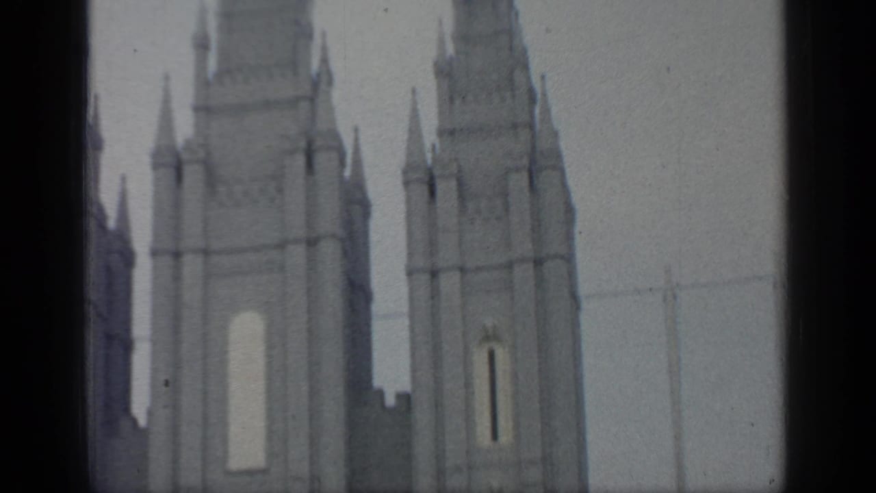 Close view of tall pale towers with narrow vertical openings.