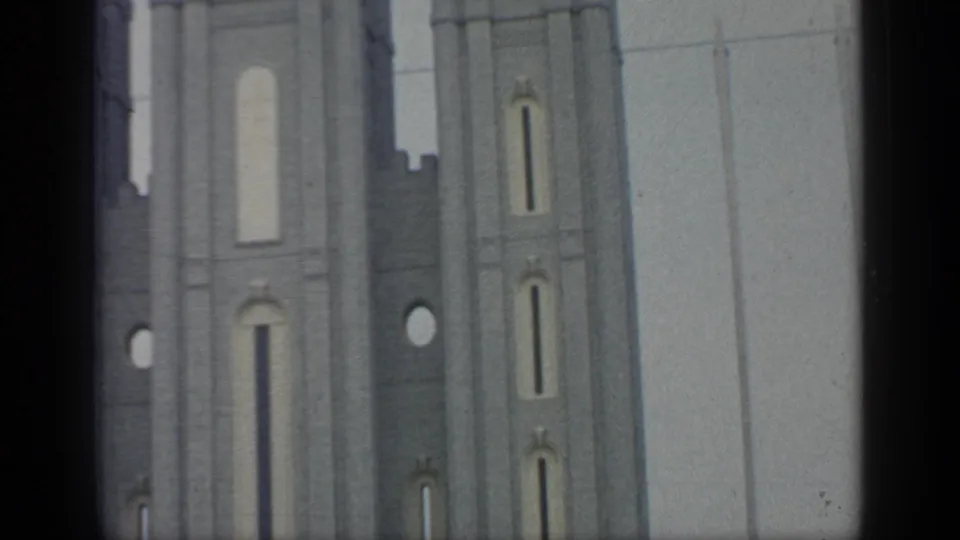 Visitor-shot 1964 fair footage showing pale tower walls, circular openings, and vertical decorative details.