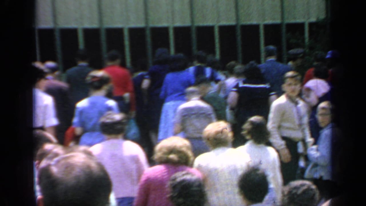 Crowd gathered near a building entrance at Flushing Meadows.
