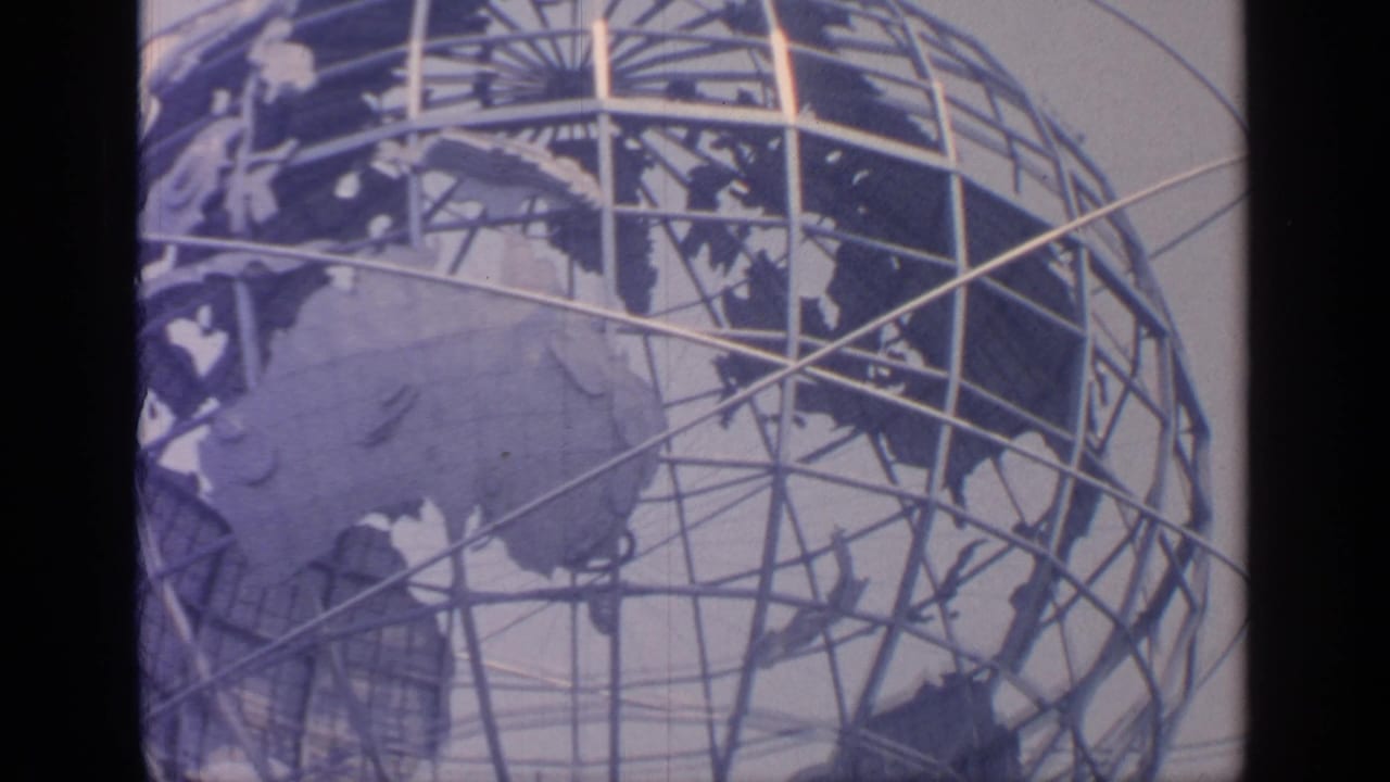 Unisphere globe sculpture with steel grid and continent shapes above fountain spray.