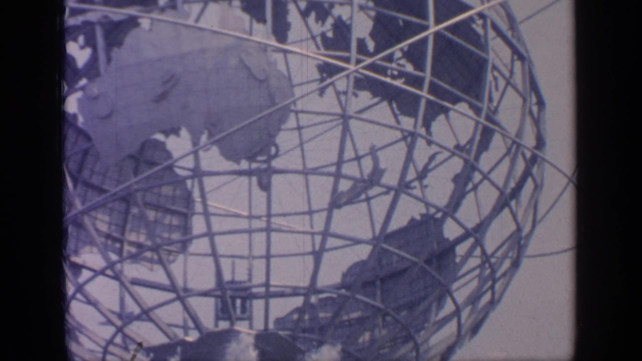 Close view of the Unisphere with steel globe framework, continents, and fountains below.