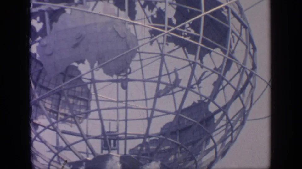 The Unisphere fills the frame in 1964 New York World's Fair footage, with fountain jets visible beneath the globe.