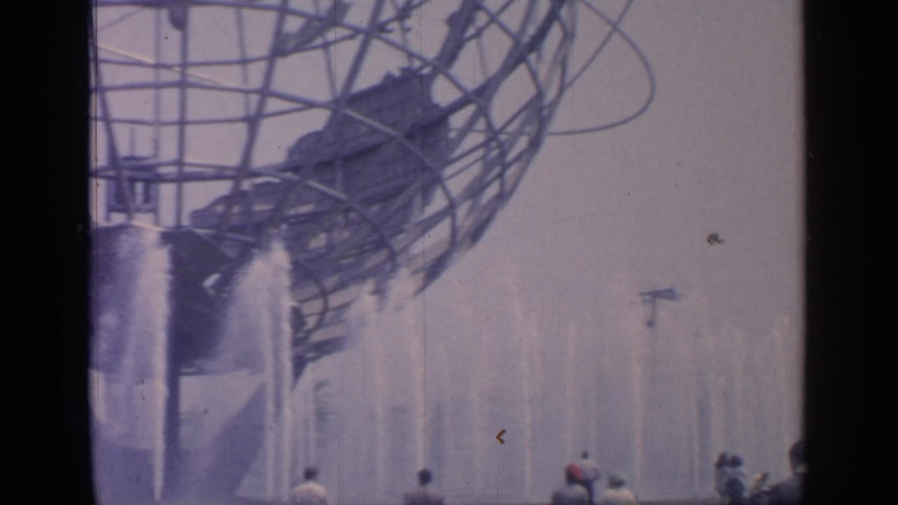 1964 Flushing Meadows World's Fair view of the Unisphere over spraying fountains, with visitors partly visible at the bottom.