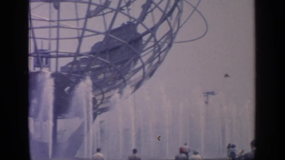1964 Flushing Meadows World's Fair view of the Unisphere over spraying fountains, with visitors partly visible at the bottom.