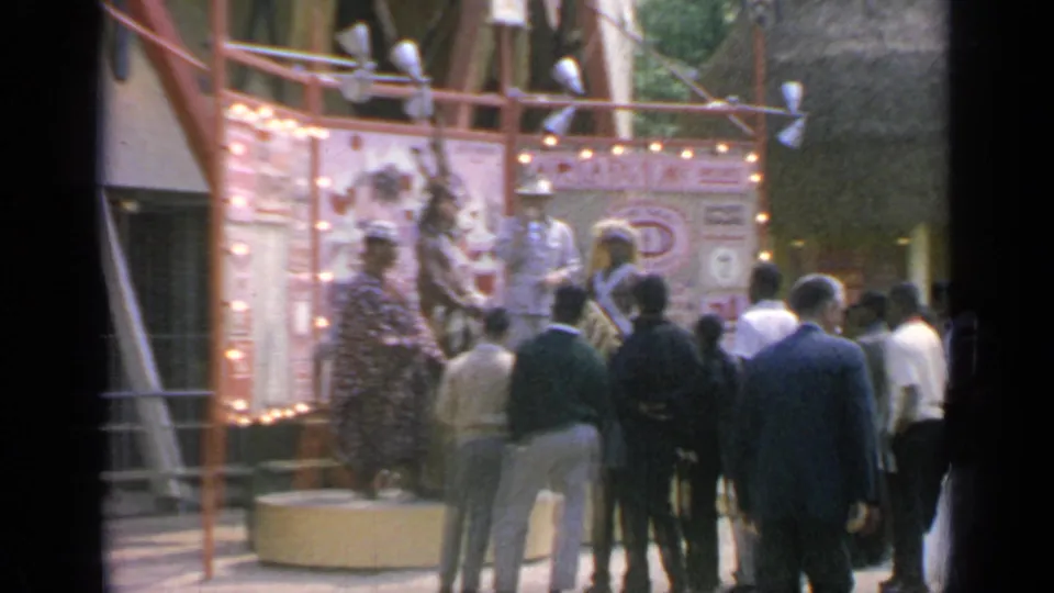 Home-movie view of visitors watching a Chinese cultural display at the 1964 World's Fair in Flushing Meadows.