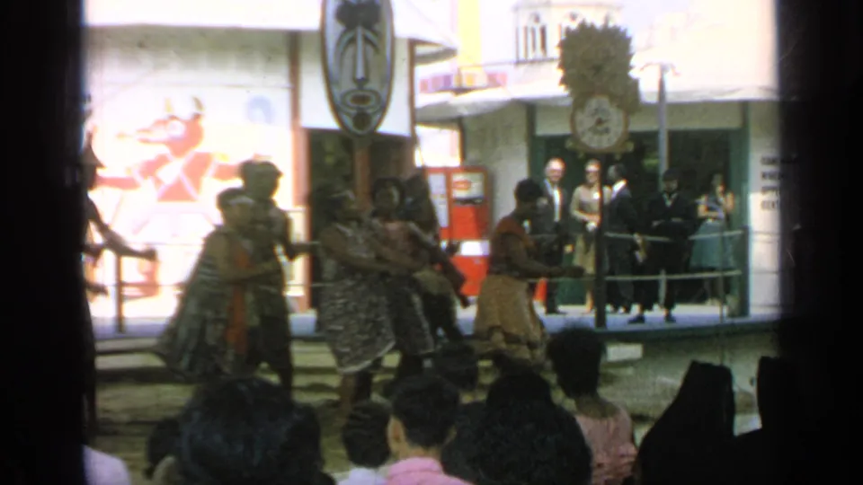 Costumed dancers perform for a crowd at the 1964 World's Fair in Flushing Meadows, seen in soft 8mm color.