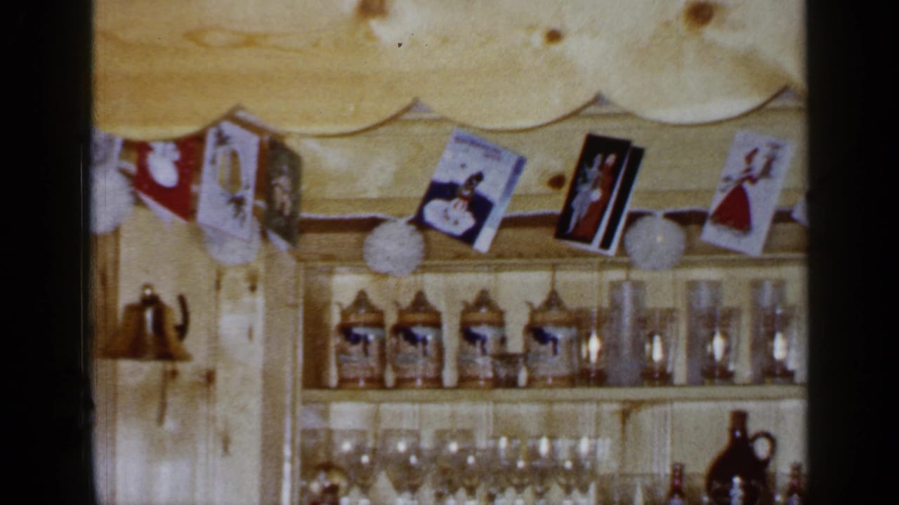 Open wooden shelves with beer steins, drinking glasses, hanging cards, and paper decorations.