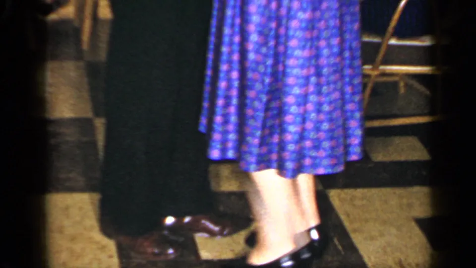 Home-movie view from Long Island in 1965 showing a patterned dress and dance steps at an indoor party.