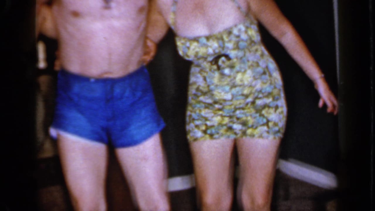 The 1966 Mineola home-movie frame shows the trio in motion, with the floral-suited woman extending one leg as the group acts playfully.