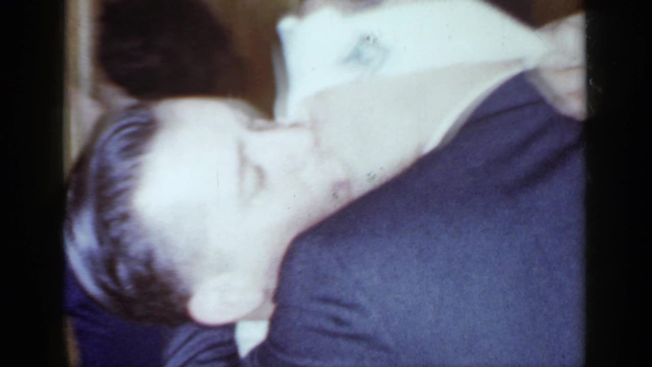 Close view of two adults leaning together during a party game.