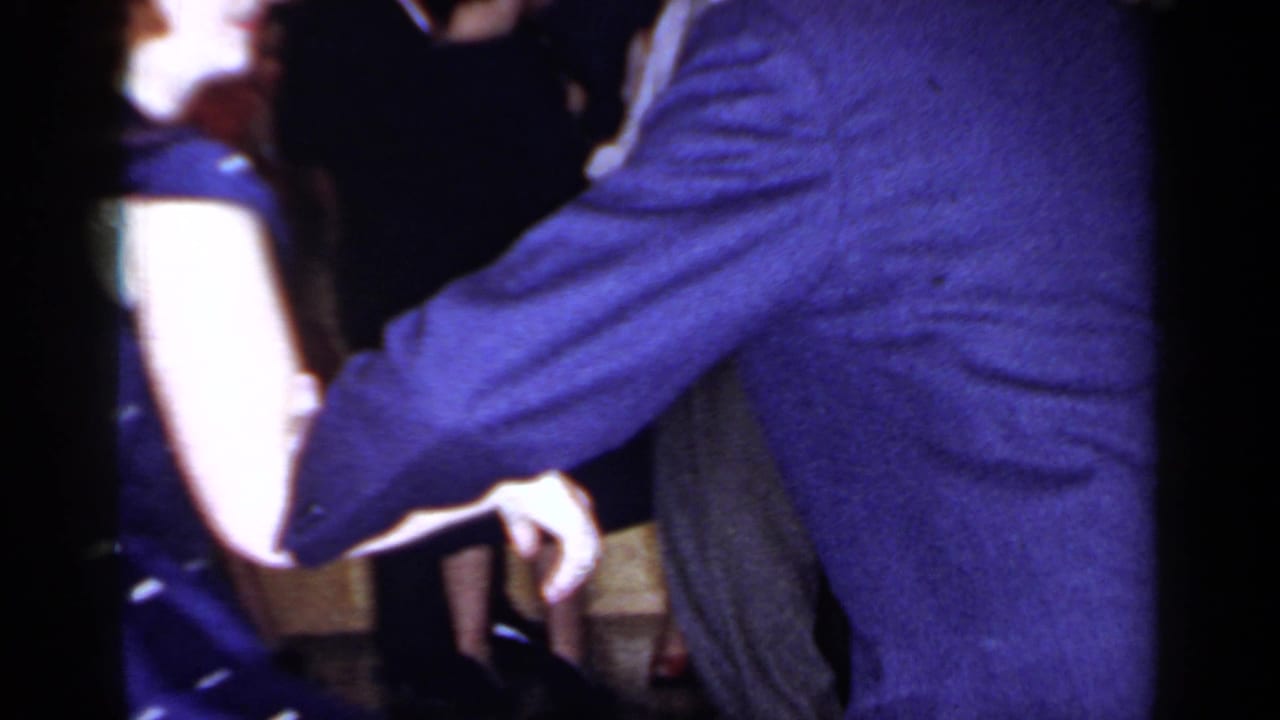 1966 Mineola party frame with a close view of adults dancing or passing through a crowded interior.