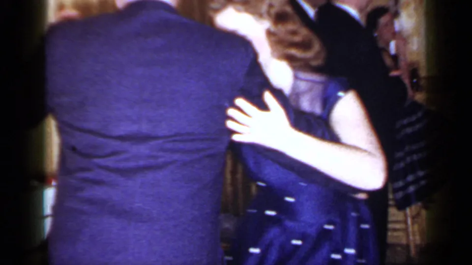 A 1966 Mineola ballroom scene shows the couple mid-dance, framed close with guests in suits and dresses behind them.
