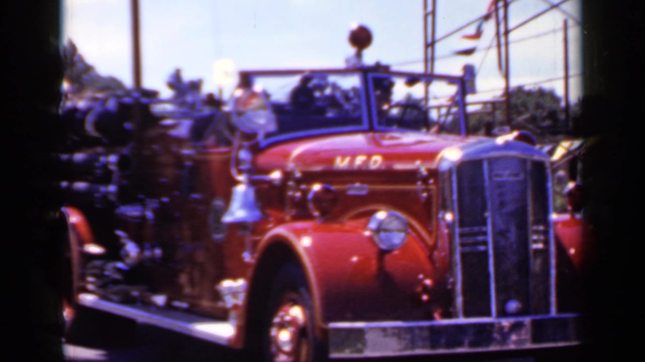 Red M.F.D. fire truck seen from the front with driver area visible.