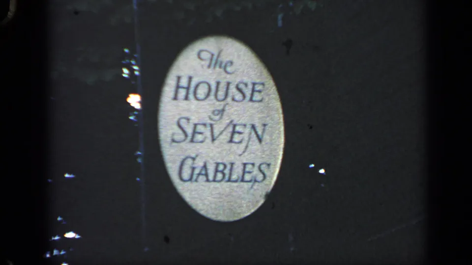 Close 1968 Massachusetts home-movie view of the House of Seven Gables sign in a dusk landmark shot.