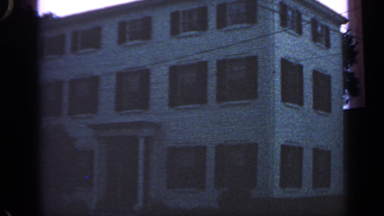 The Massachusetts lodging exterior remains centered, with shuttered windows and visible 8mm frame borders.