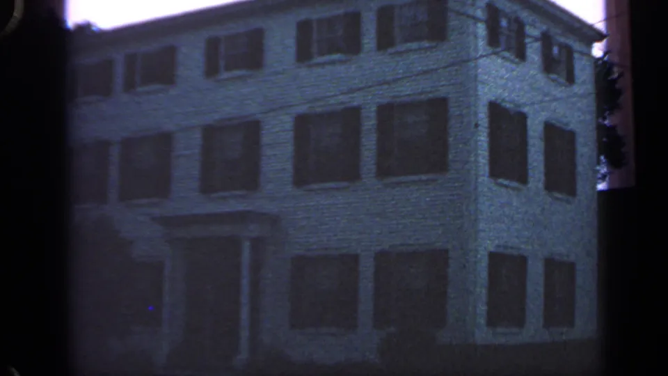 The Massachusetts lodging exterior remains centered, with shuttered windows and visible 8mm frame borders.