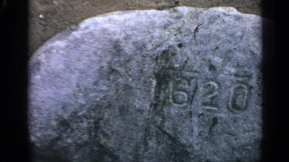 1969 Massachusetts 8mm still showing the same weathered rock, with the 6/20 inscription lower in the frame.