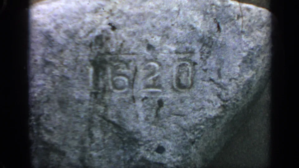 1969 Massachusetts frame with the 6/20 carving more centered on a weathered rock surface, bordered by dark film edges.