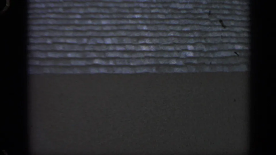 The final frame shows the shingled roof over a darker wall plane, with visible dust and grain from the 8mm scan.